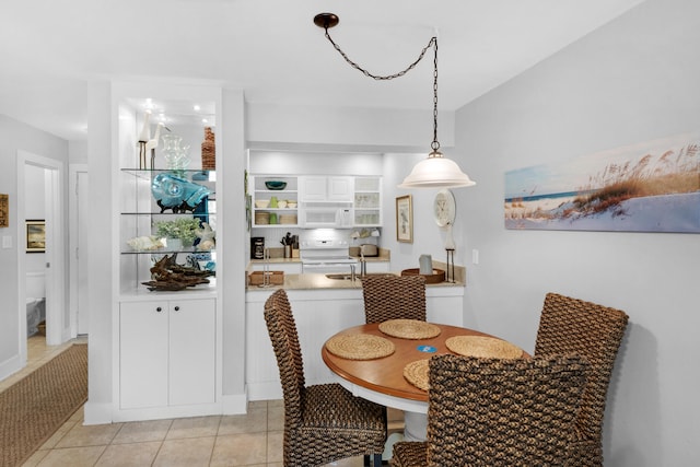 dining area featuring light tile patterned flooring