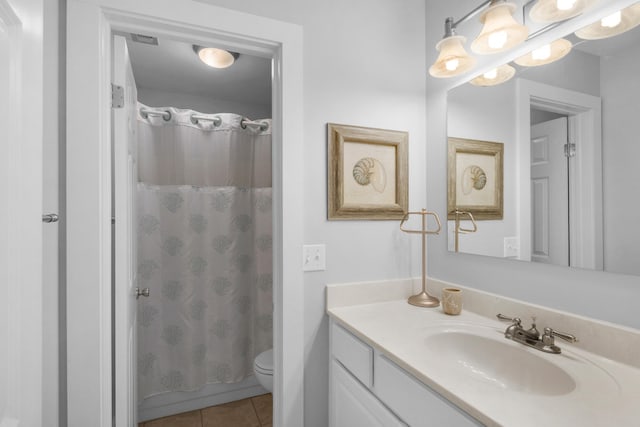 bathroom featuring walk in shower, tile patterned floors, vanity, and toilet