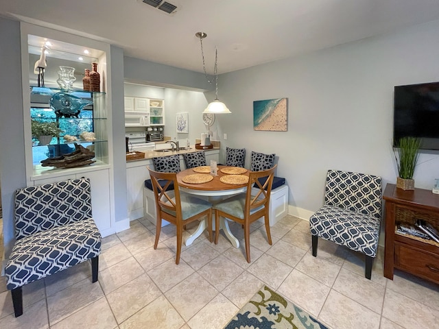 dining room with light tile patterned flooring and sink