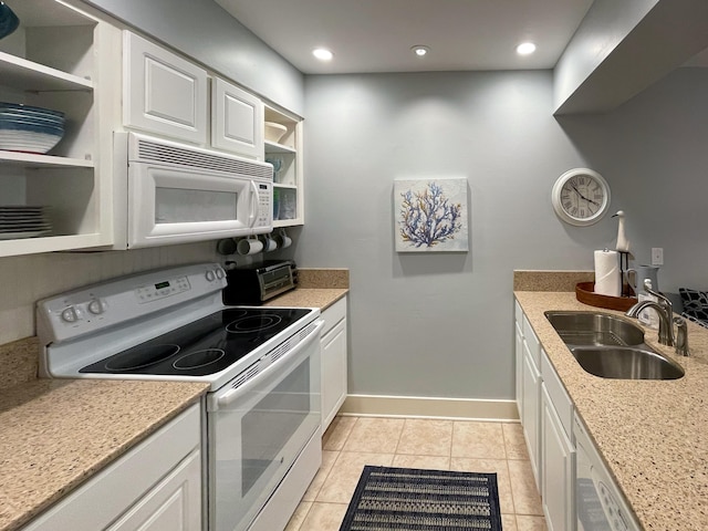 kitchen featuring light stone counters, white cabinets, white appliances, sink, and light tile patterned floors