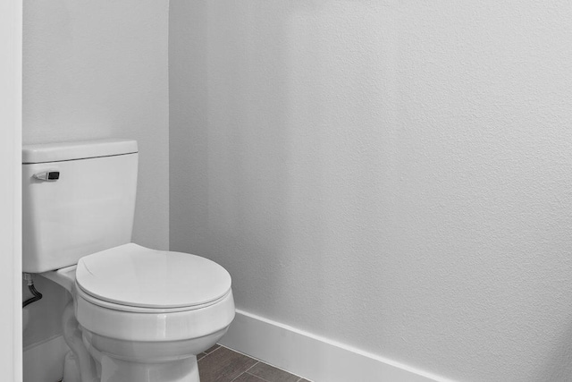 bathroom featuring toilet and wood-type flooring