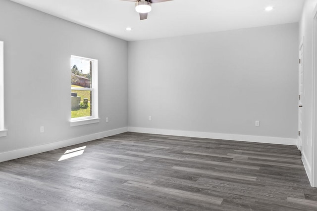 empty room with ceiling fan and dark wood-type flooring