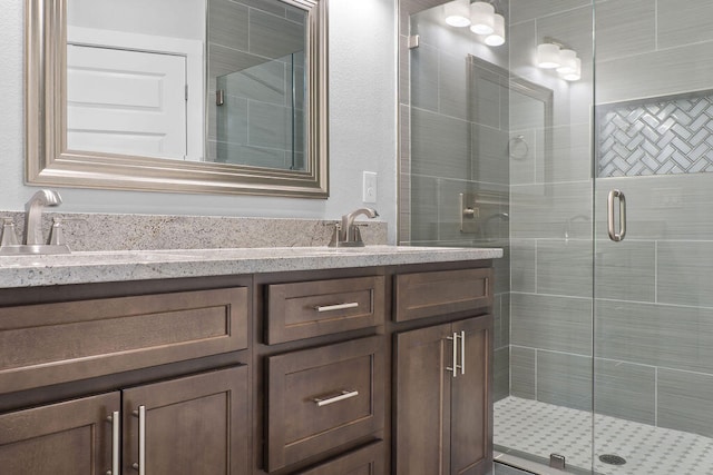 bathroom with an enclosed shower and vanity