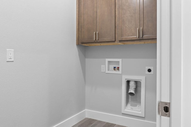 clothes washing area featuring hookup for an electric dryer, hookup for a washing machine, cabinets, and hardwood / wood-style flooring