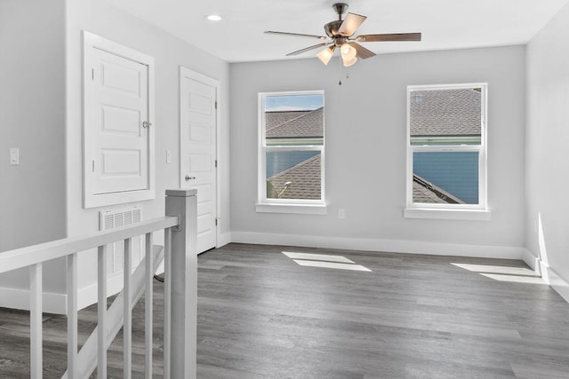 spare room featuring dark hardwood / wood-style floors and ceiling fan