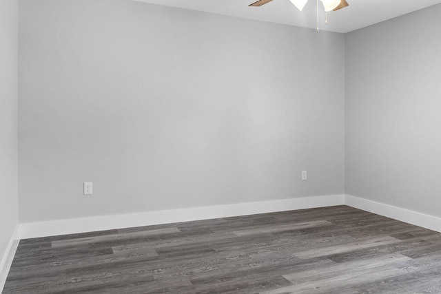 spare room with ceiling fan and dark hardwood / wood-style flooring