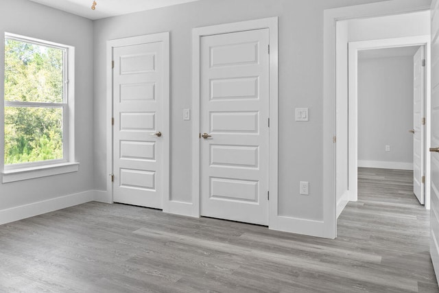 unfurnished bedroom with light wood-type flooring