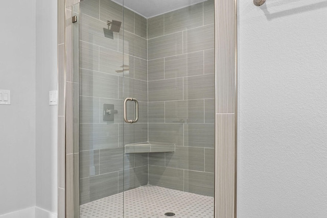 bathroom with a shower with door