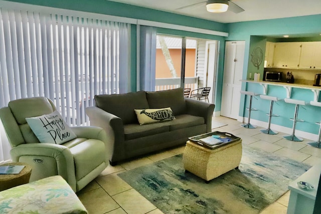 tiled living room with ceiling fan