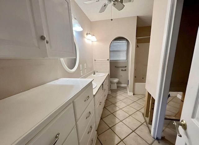 bathroom featuring ceiling fan, vanity, tile patterned flooring, and toilet