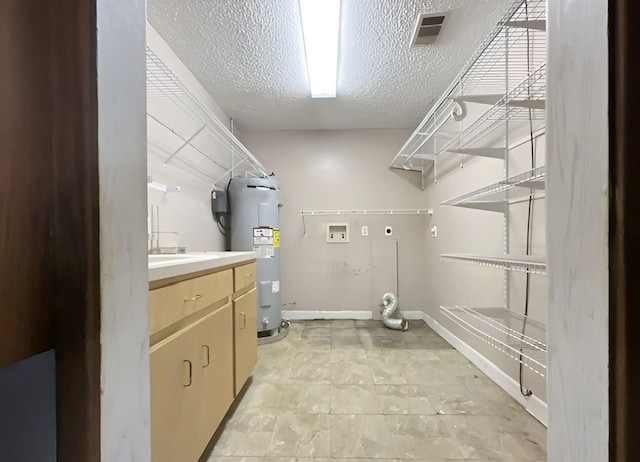 laundry area with electric dryer hookup, electric water heater, washer hookup, cabinets, and a textured ceiling