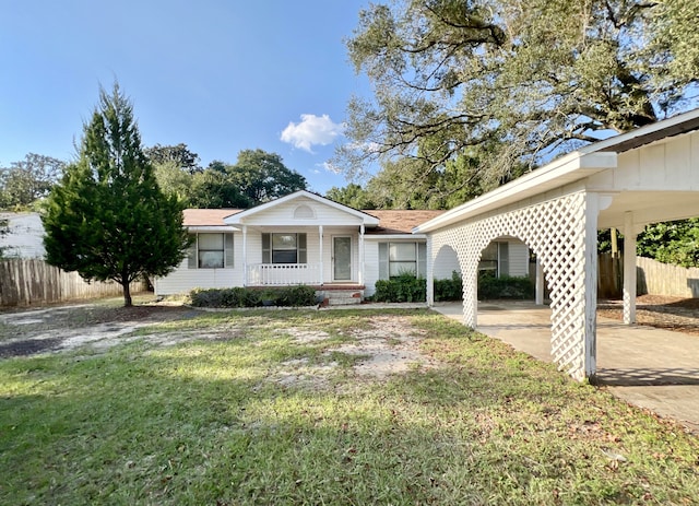 ranch-style house featuring a front lawn, a porch, and a carport