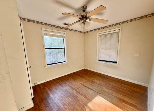 spare room featuring ceiling fan and hardwood / wood-style floors