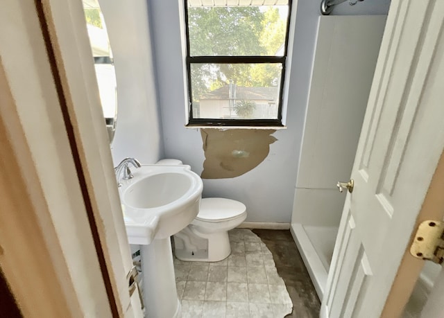 bathroom featuring walk in shower and toilet