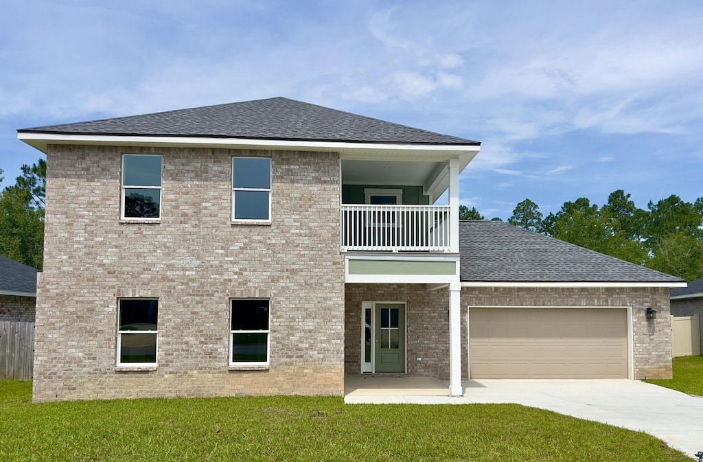 4540 Hermosa Rd, Crestview, FL 32539 - rear view of property featuring a balcony, a lawn, concrete driveway, and a shingled roof