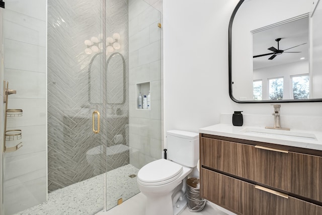 bathroom with vanity, ceiling fan, toilet, and walk in shower