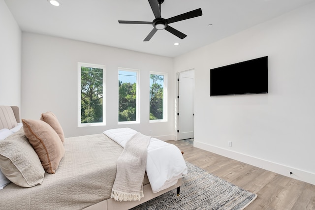 bedroom featuring light hardwood / wood-style flooring and ceiling fan