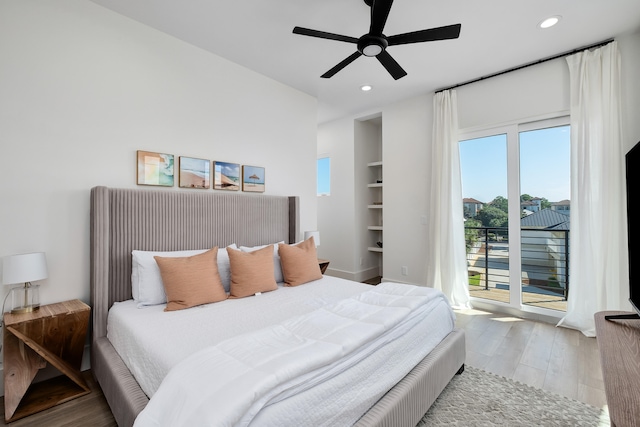 bedroom featuring access to exterior, hardwood / wood-style flooring, and ceiling fan