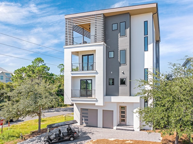 contemporary house with a balcony and a garage