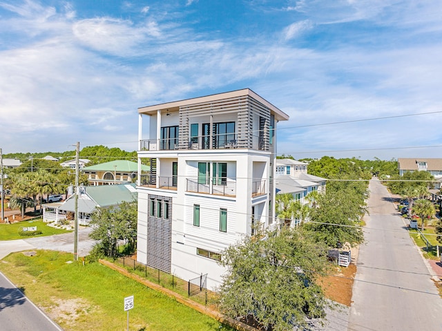 view of front of property with a front lawn and a balcony