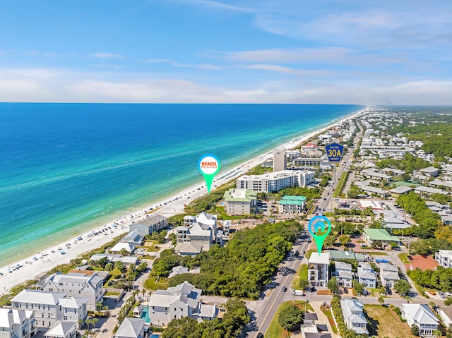 bird's eye view featuring a water view and a beach view