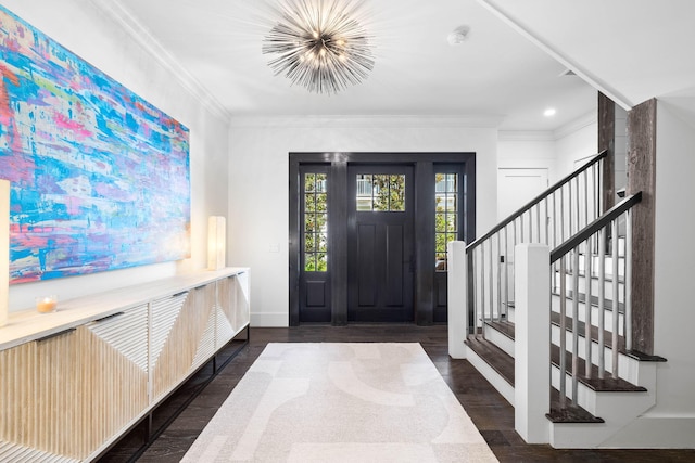 entryway featuring a notable chandelier, dark wood finished floors, stairway, ornamental molding, and baseboards