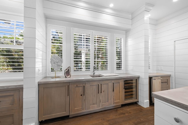 bar featuring sink, wine cooler, dark hardwood / wood-style floors, wood walls, and crown molding