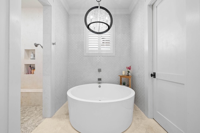 bathroom with a notable chandelier, tile walls, a freestanding bath, ornamental molding, and tile patterned flooring