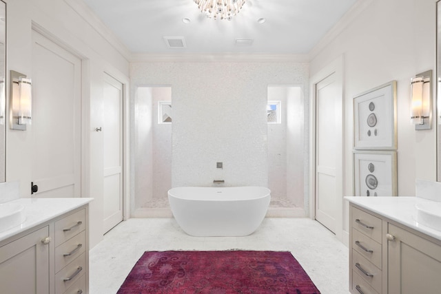 bathroom featuring ornamental molding, two vanities, a freestanding bath, and a shower stall