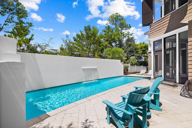 view of swimming pool with a patio, fence, and a fenced in pool