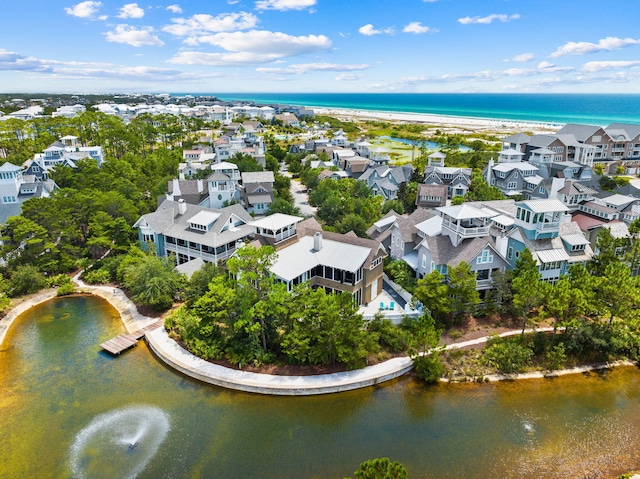 aerial view featuring a water view, a residential view, and a view of the beach