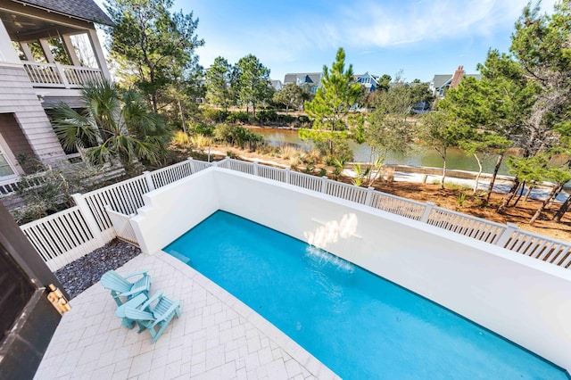 view of swimming pool with a water view and a patio