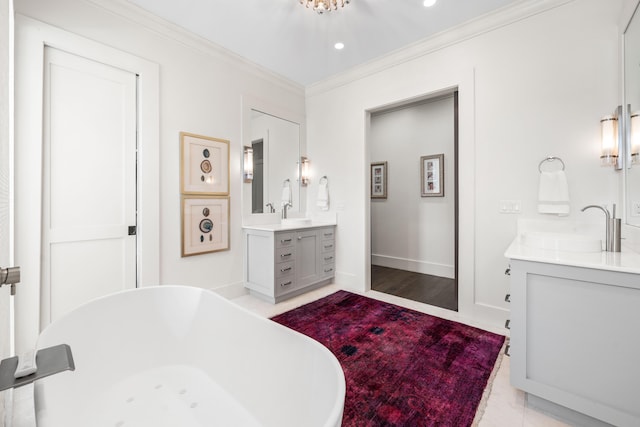 full bathroom with crown molding, recessed lighting, two vanities, a freestanding bath, and baseboards