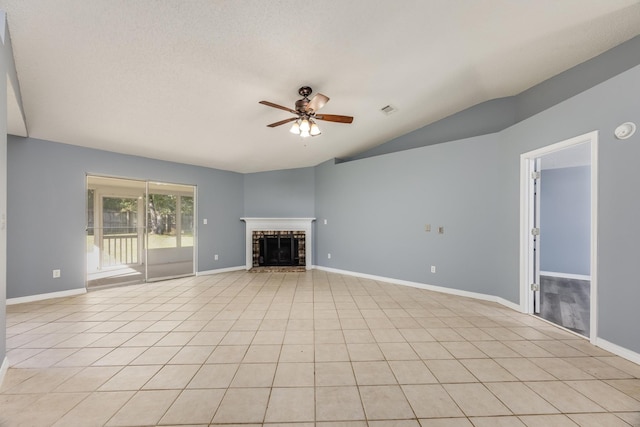 unfurnished living room with ceiling fan, light tile patterned flooring, lofted ceiling, and a textured ceiling