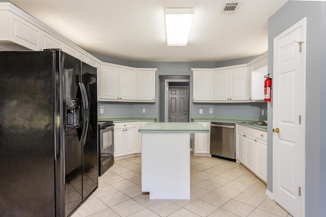 kitchen featuring light tile patterned floors, black appliances, a center island, and white cabinetry