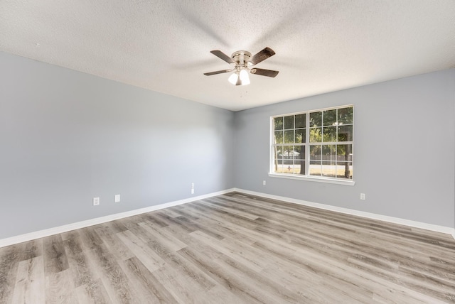 empty room with ceiling fan, a textured ceiling, and light wood-type flooring