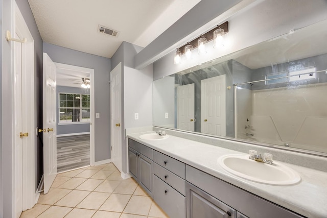 bathroom with tile patterned floors, ceiling fan, vanity, and shower / washtub combination