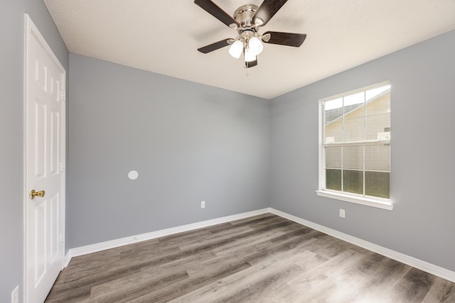 empty room featuring ceiling fan and hardwood / wood-style floors