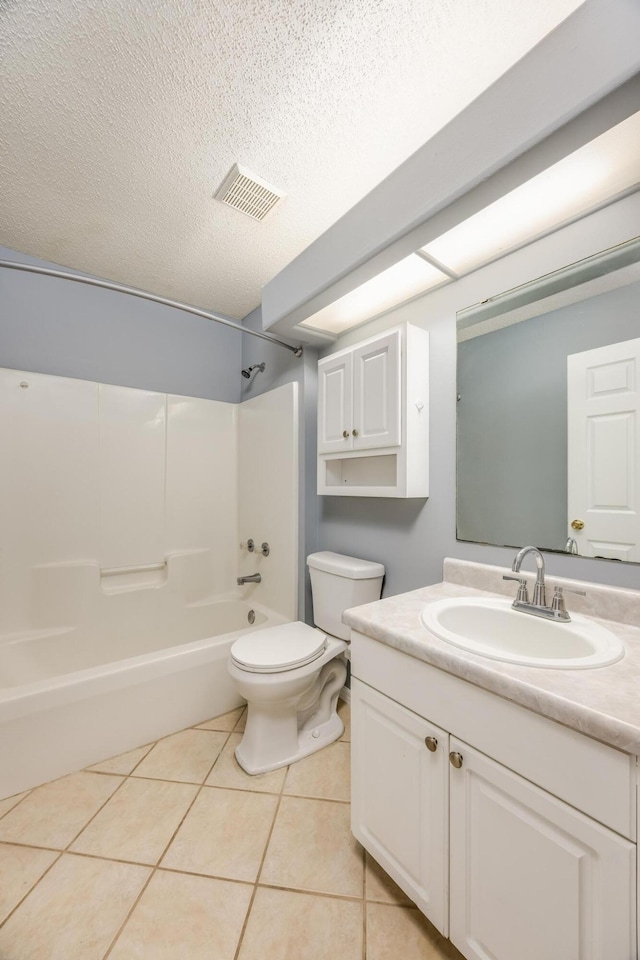 full bathroom featuring vanity, tile patterned flooring, shower / washtub combination, toilet, and a textured ceiling