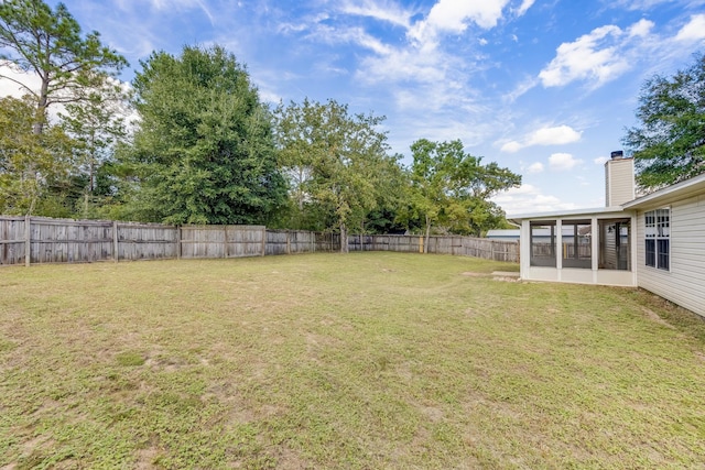 view of yard with a sunroom