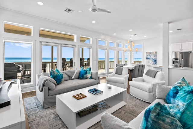 living room featuring hardwood / wood-style floors, a water view, and a healthy amount of sunlight