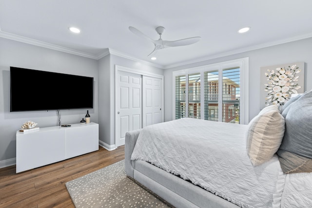 bedroom with crown molding, ceiling fan, a closet, and dark hardwood / wood-style flooring