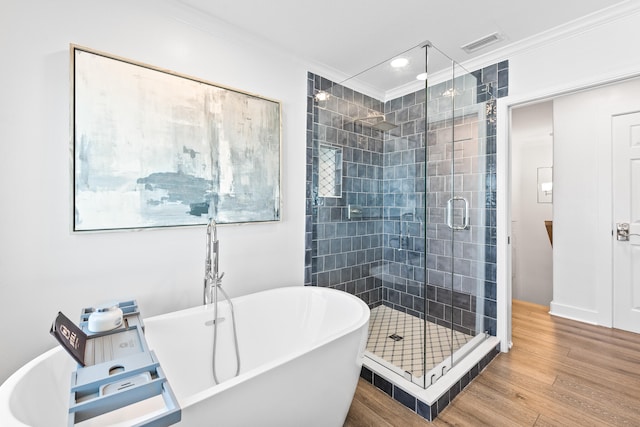 bathroom with separate shower and tub, ornamental molding, and hardwood / wood-style flooring