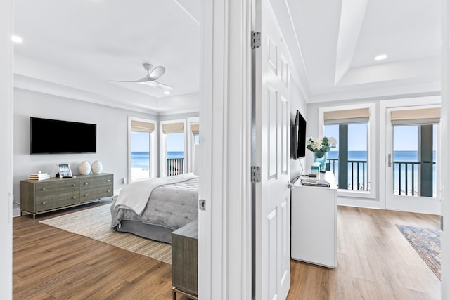 bedroom with access to exterior, multiple windows, ceiling fan, and light wood-type flooring