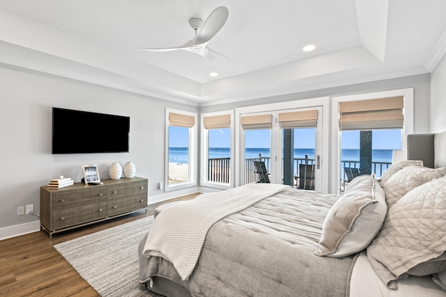 bedroom with a water view, ceiling fan, dark hardwood / wood-style flooring, access to outside, and ornamental molding