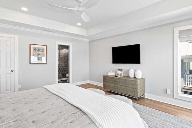 bedroom featuring wood-type flooring, ensuite bathroom, and ceiling fan