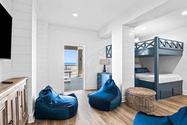 bedroom featuring hardwood / wood-style flooring and ornamental molding