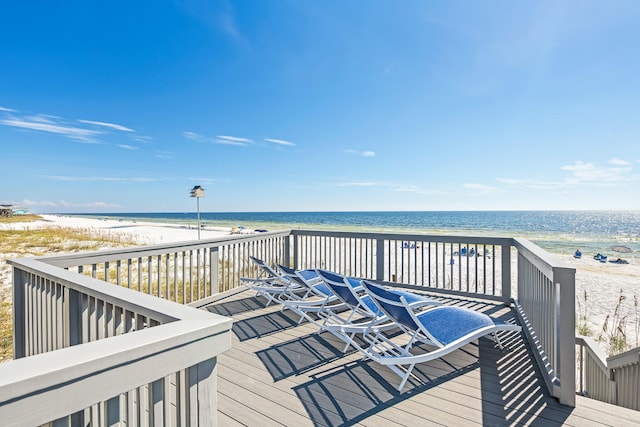 deck featuring a beach view and a water view