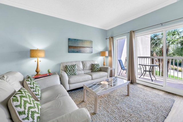 living room featuring crown molding, hardwood / wood-style flooring, and a textured ceiling