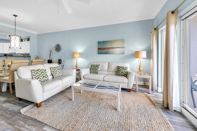 living room featuring ornamental molding, hardwood / wood-style flooring, and ceiling fan